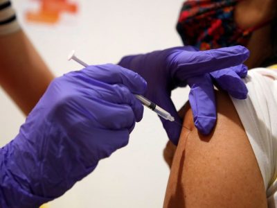A medical worker administers a dose of the "Comirnaty" Pfizer-BioNTech COVID-19 vaccine to a patient at a coronavirus disease (COVID-19) vaccination center installated in front of Paris town hall, France, July 7, 2021. REUTERS/Sarah Meyssonnier